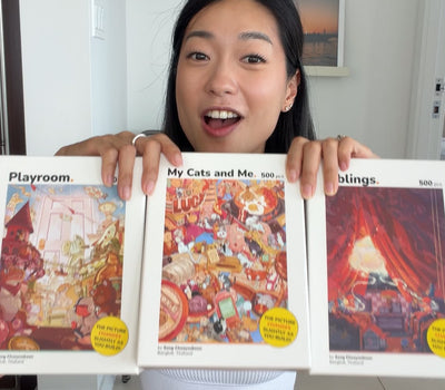Ginny holding the three Perspective Puzzle boxes for size