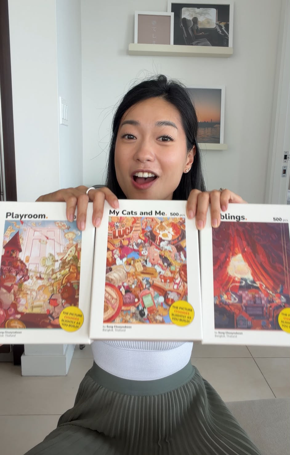 Ginny holding the three Perspective Puzzle boxes for size