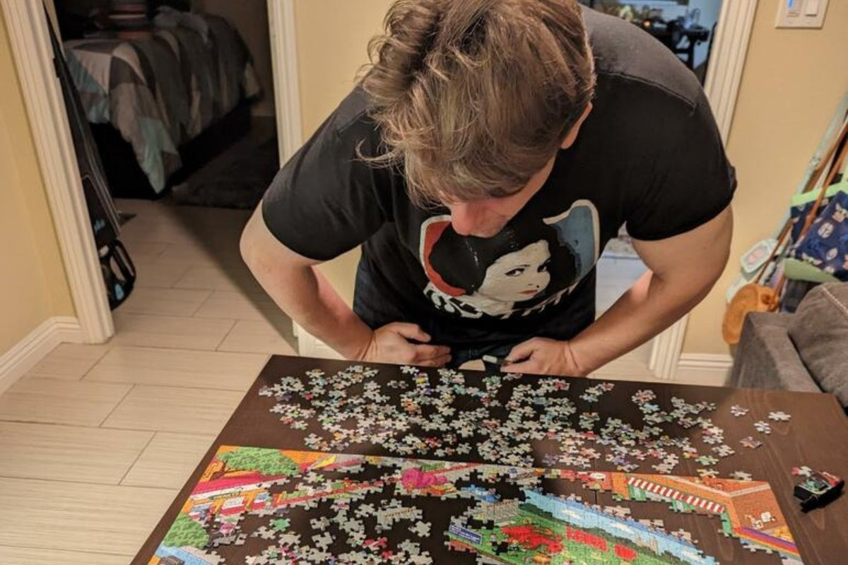 A skeptical-looking guy leaning in over the puzzle